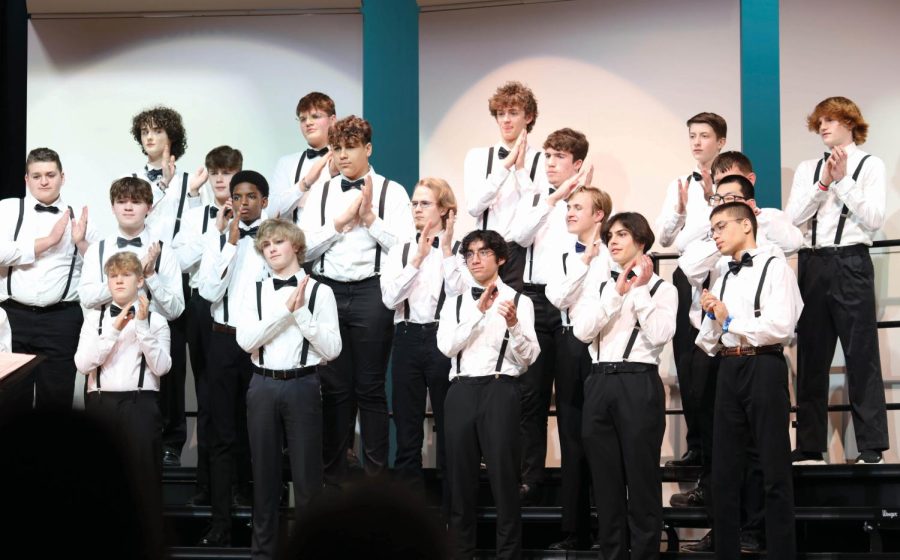 In unison, the boys choir claps during their songs. 