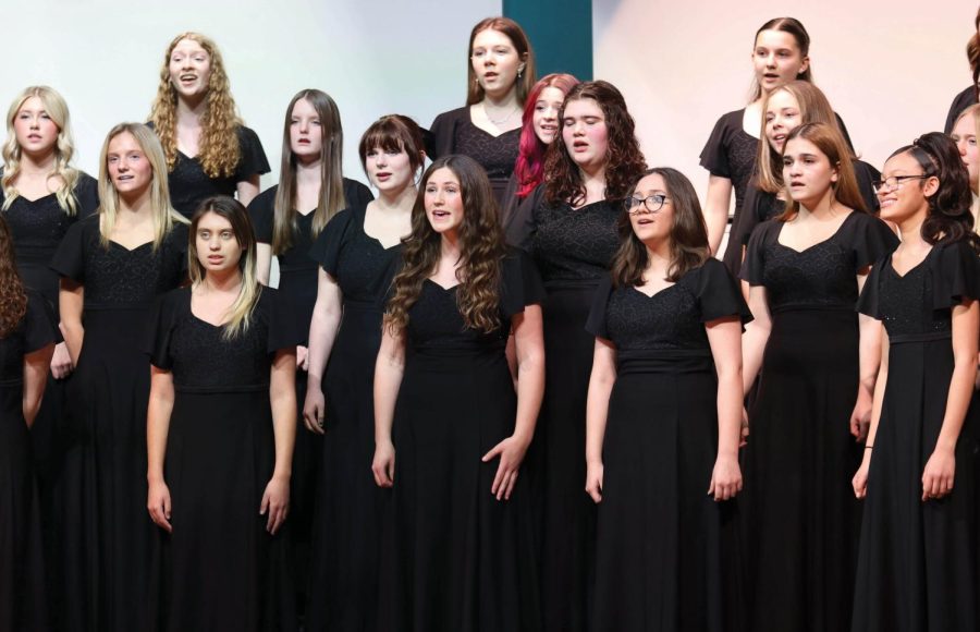 All together on stage, the girls choir sings a few songs they have been working on.