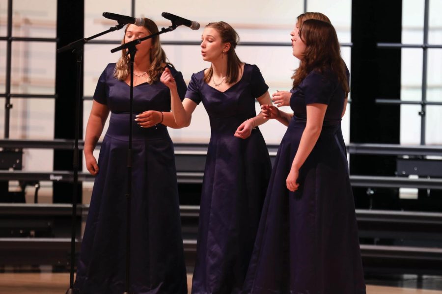 Singing, junior Grace Cormany, leads the Fox Trots in an up-beat song.