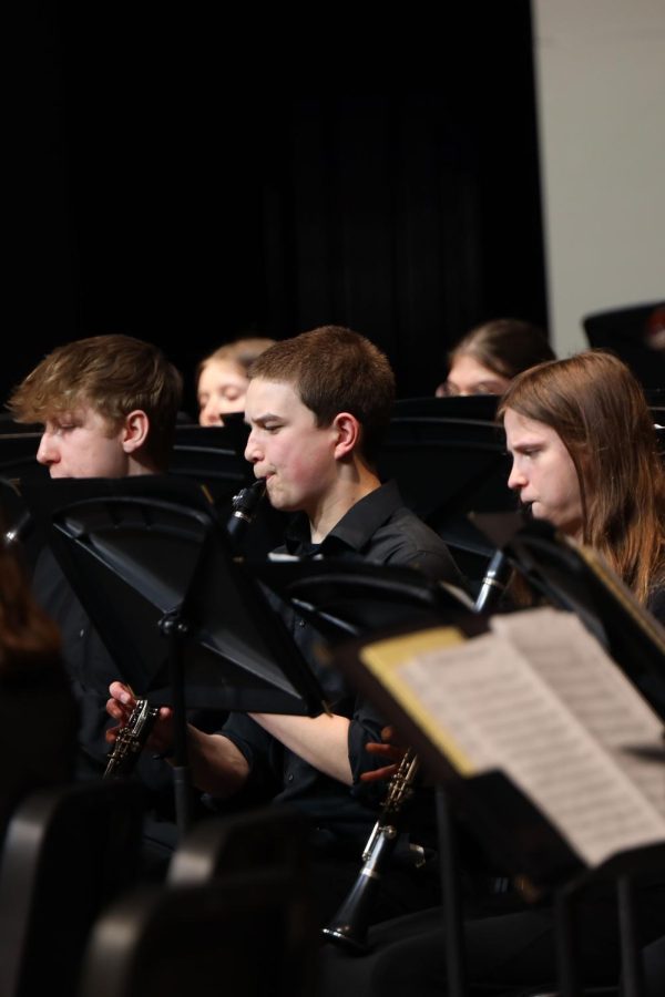 During the concert band performance, sophomore Kai McGarry plays the clarinet.