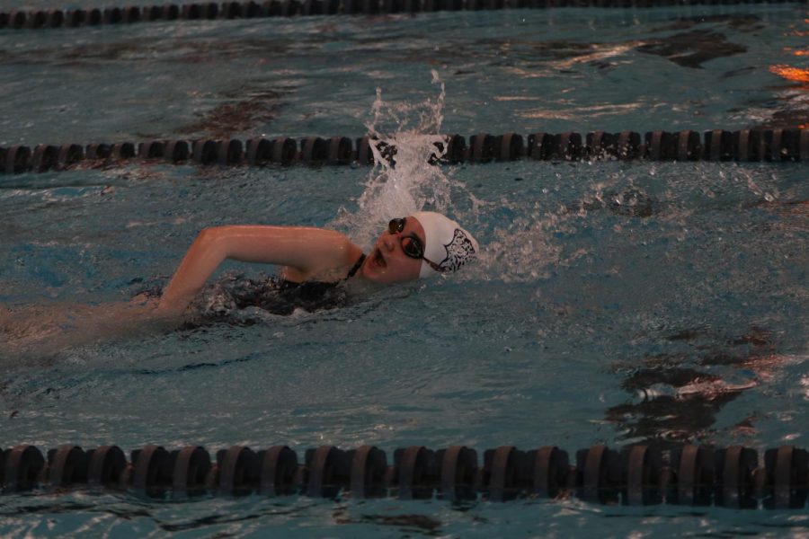 Turning to the side to breathe, junior Gabriella Nielson competes in the 100 meter freestyle.