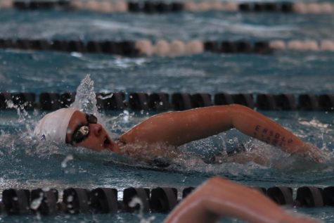 Competing in the 100 meter freestyle, sophomore Evalyn Dill comes up for a breath. 