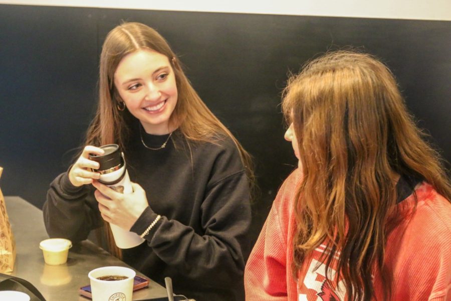 Senior Anna Stottlemyre engages in conversation with senior Adisyn Hopkins while out at dinner with her friends. I like going out to dinner with my friends because I enjoy spending time with them Stottlemyre said Wednesday, March 8. 