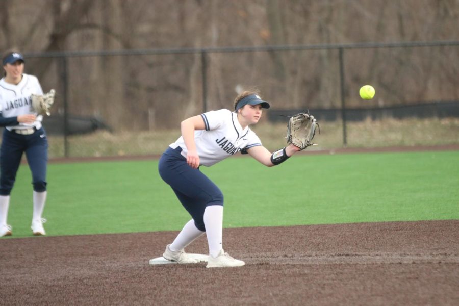 Crouching down, senior Adisyn Hopkins prepares to catch the ball.
