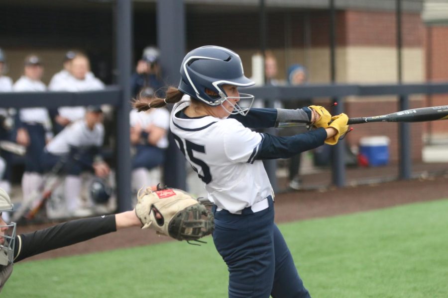 Swinging the bat, sophomore Madi Lehr hits the ball onto the field.