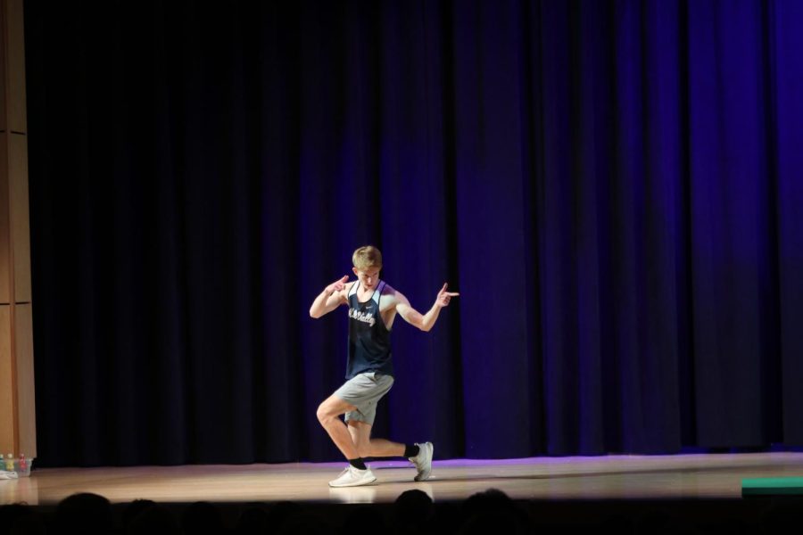 Pointing to the audience, junior Wil Lehan strikes a pose during the introduction portion.