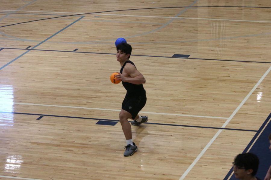 Junior Walt Midyett prepares to throw a dodgeball at the other team.