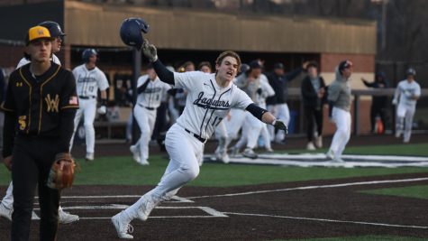 Running into home, freshman Beau Peterson celebrates the teams victory. 