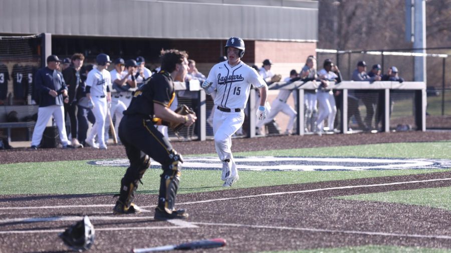 Trying to beat the ball, junior Reid Livingston speeds to home plate. 