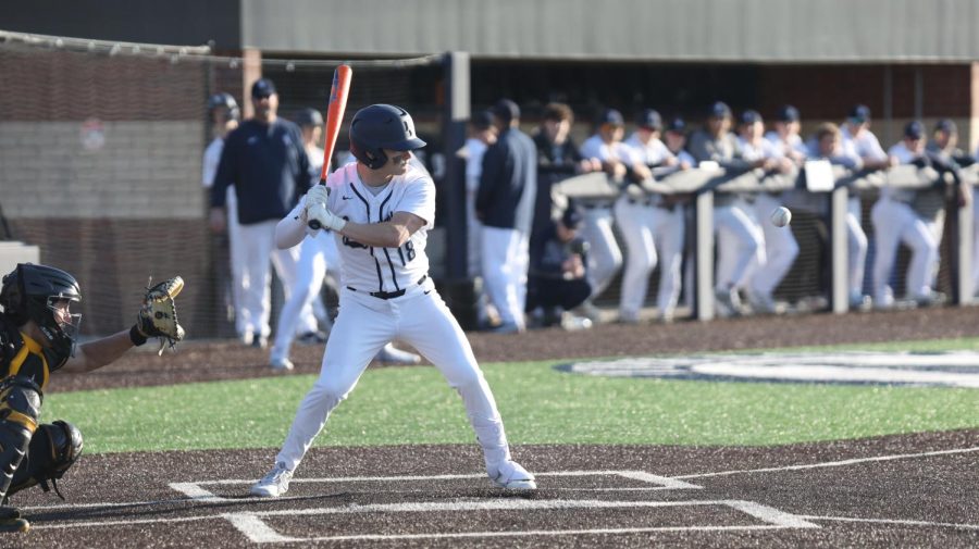 Ready to swing, junior Drew Snyder waits for the ball in front of him. 