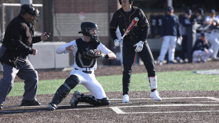 After catching the ball, senior Matt Weis gets ready to throw out the runner on second. 