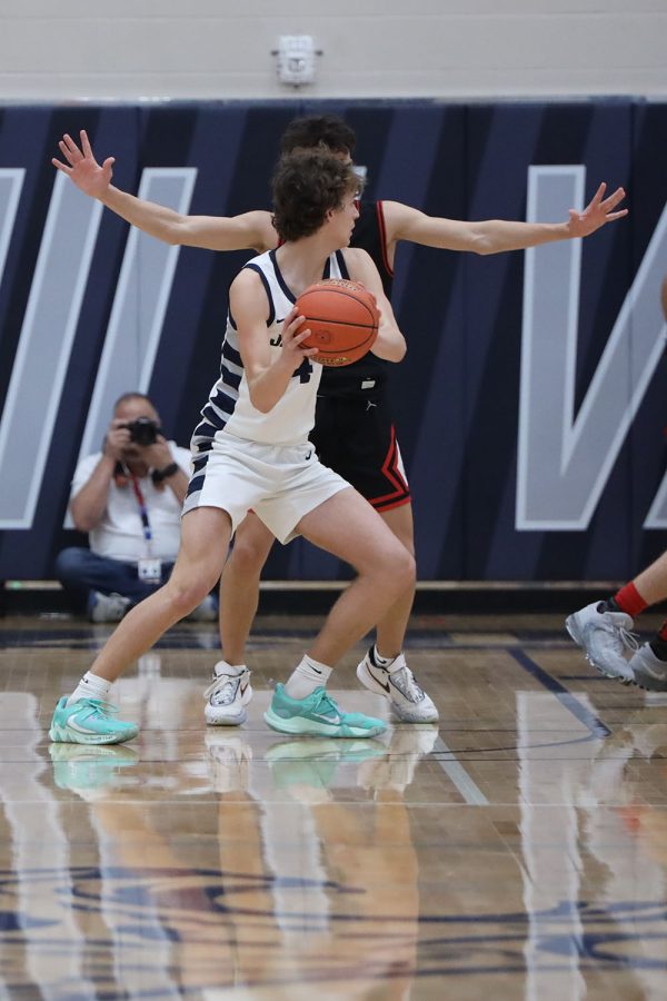 Looking for an open teammate, freshman Reece Riedel gets ready to pass the ball. 
