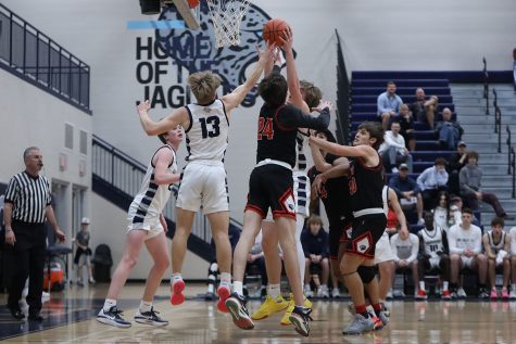 Jumping up, junior Bryant Wiltse attempts to get the rebound. 