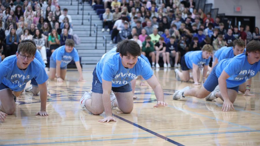 During the Silver Studs performance, senior Parker Volski crawl forward. 