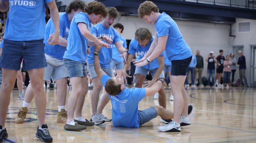 With senior Hayes Miller on the floor, senior Toby Kornis along with Silver Studs try to revive him. 