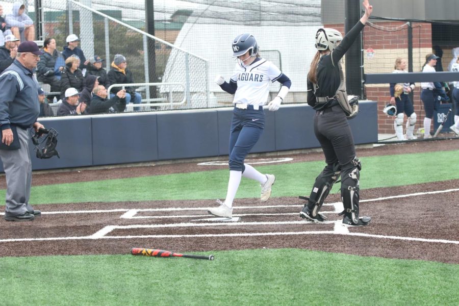 Touching home plate, senior Anna Stottlemyre scores a run for the team.
