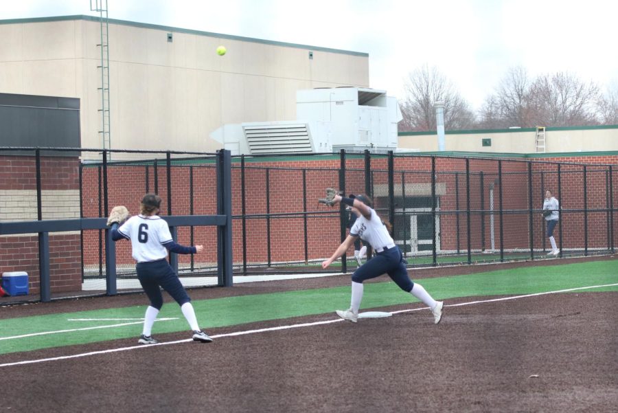 Running for the ball, junior Elly VanRheen catches a pop fly. 
