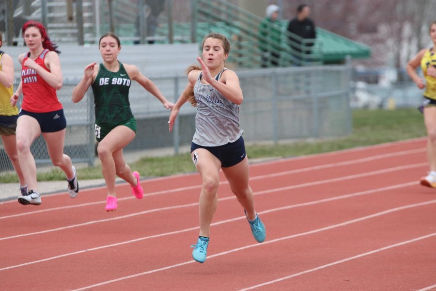 Sophomore Lauren Welch pumps her arms to gain speed in the 100 meter dash.
