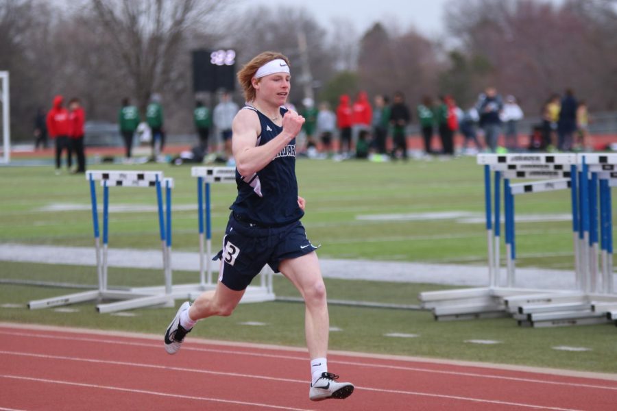 On the final stretch of the 200 meter dash, freshman Garrett Cox looks ahead to the finish line.