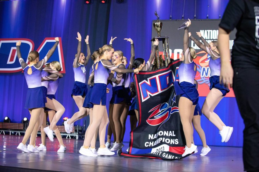 Holding their trophy high, the Silver Stars celebrate their national title in the Game Day dance division.