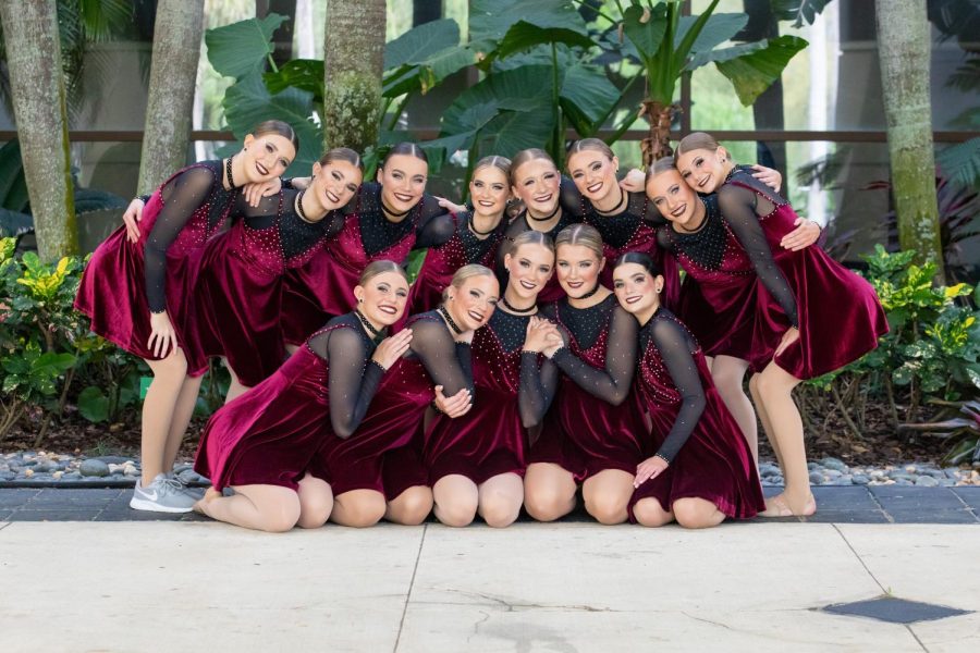Smiling with confidence, the Silver Stars pose for a photo in their jazz routine outfits.