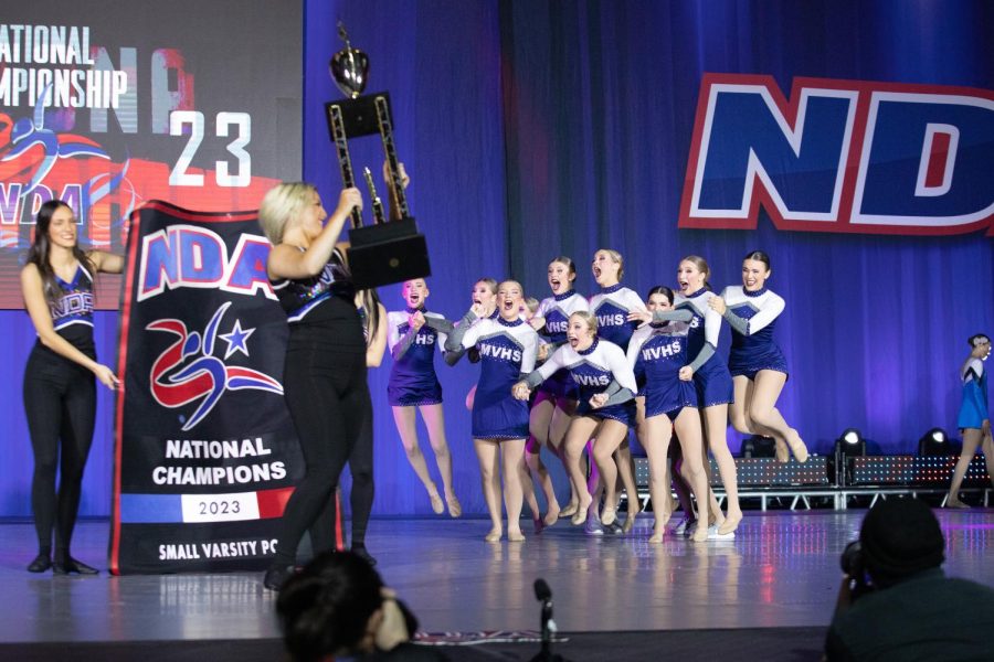 Ecstatic with victory, the Silver Stars cheer as they are presented with their national award trophy for the small varsity pom division.