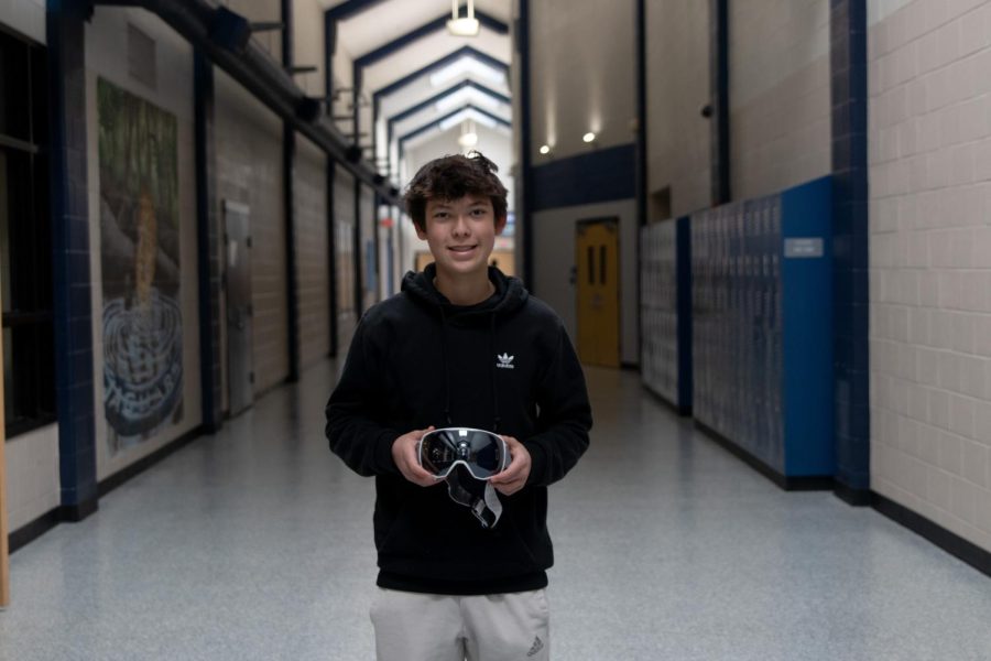 Freshman Jacob Krosky holds up his pair of ski goggles Friday, March 3. Krosky said he is packing his goggles because he will be going skiing in Colorado. 