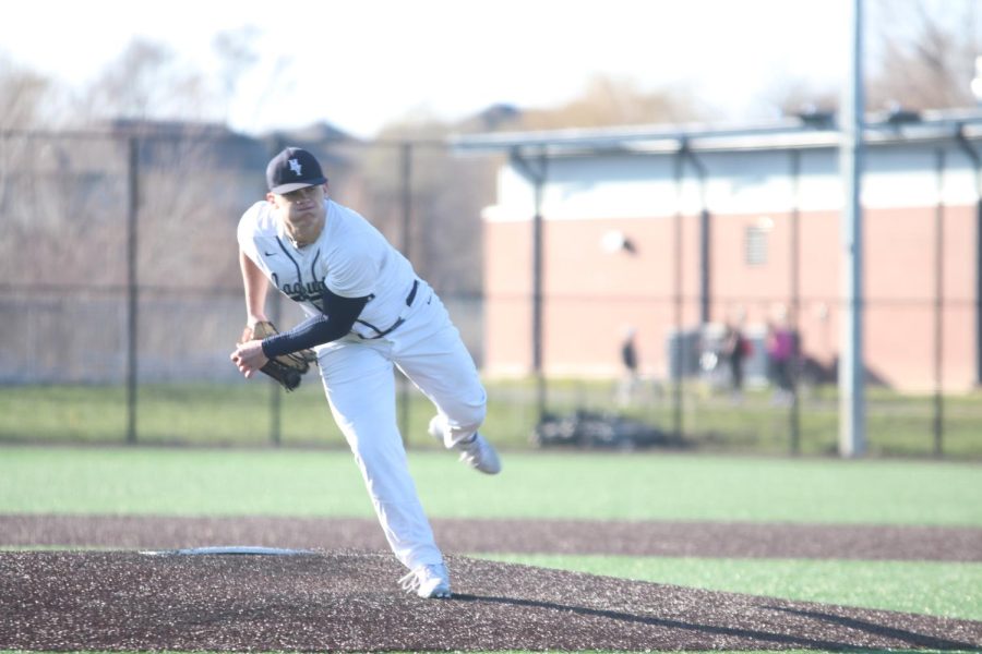 Finishing his pitch, senior Grant Rutkowski brings his foot around. 