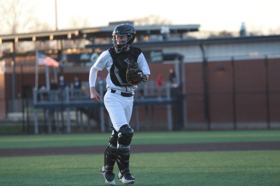 Looking towards his coach, senior Matt Weis runs back to his position.