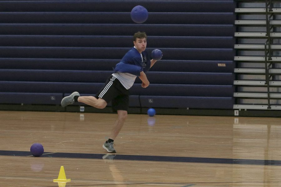 Focused, senior Gabe Martin aims to get his opponent out.