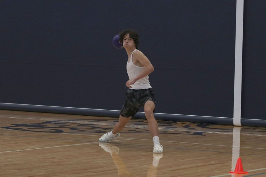 Preparing to throw the dodgeball, freshman Anderson Strack makes an attempt to get a member of the opposing team out.