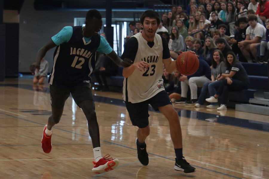 Running down the court, paraprofessional Andrew Bock advances to the basket.