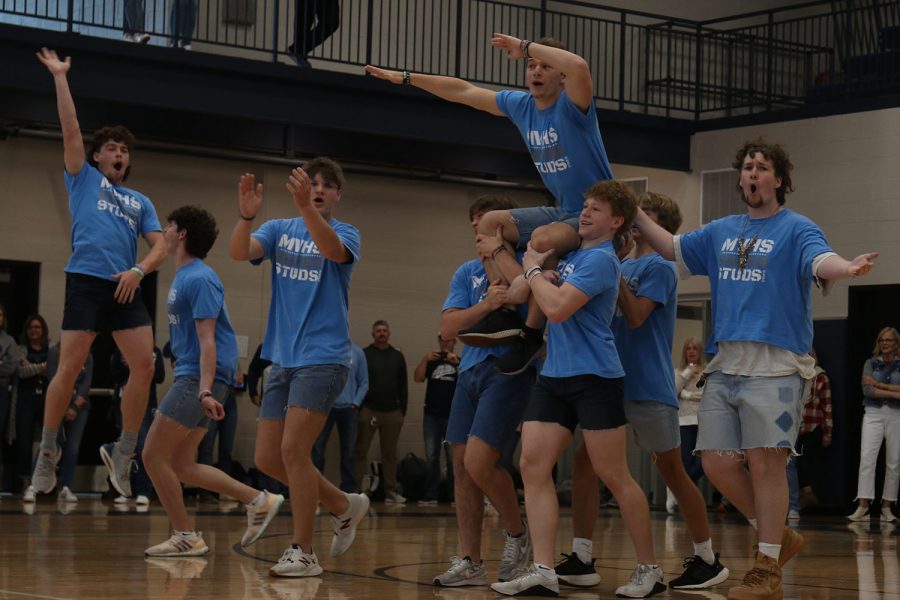 Being lifted up by other Silver Studs, senior Hayes Miller puts his hands in the air.