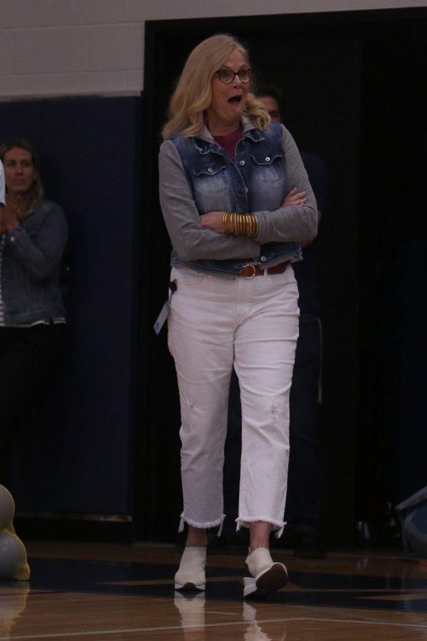 Jaw dropped, principal Dr. Gail Holder walks to the gym floor to receive her award.