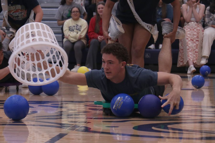 With a laundry basket in hand, senior Luke Shielder grabs the dodgeball to add to his collection.