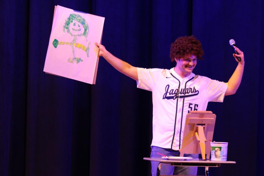 Taking inspiration from Bob Ross, senior Parker Volski paints a picture of audience member senior Grant Rutkowski.
