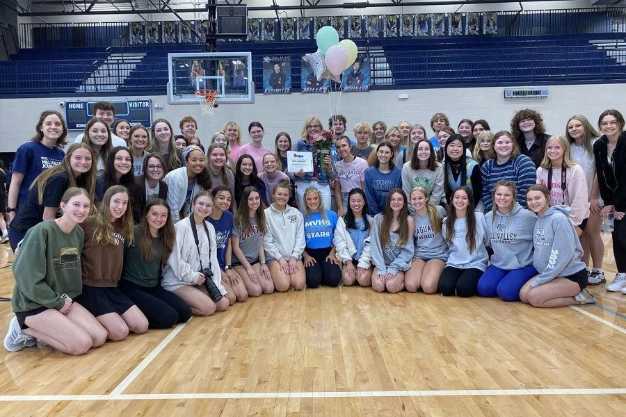 Smiling for a photo, members of the journalism program take a picture with principal Dr. Gail Holder after she won the 2023 Administrator of the Year award by the Kansas Scholastic Press Association.