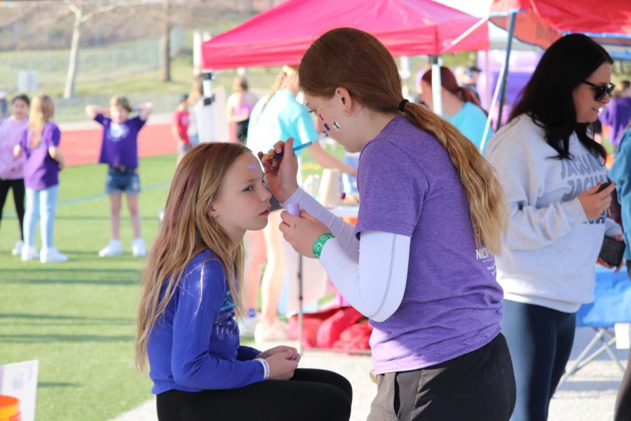 Waiting patiently, a student gets her face painted at one of the Relay for Life booths. 