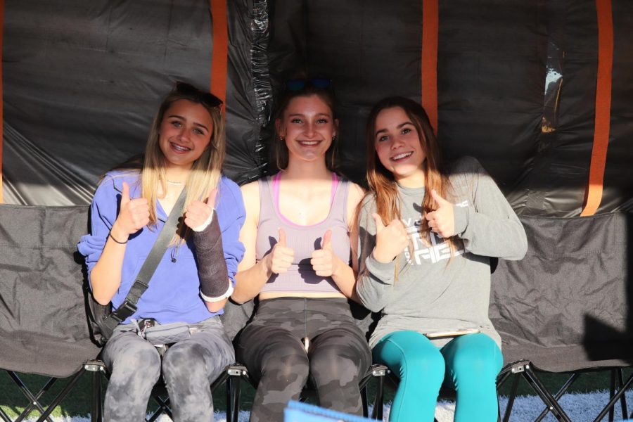 Smiling, sophomores Ava Lamothe, Kate Martin, and Lauren Welch sit in the jail booth and wait to be released. 