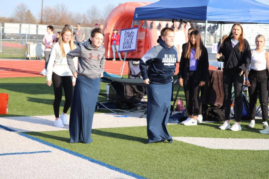 Students hop in their sacks to the finish line of the potato sack race. 