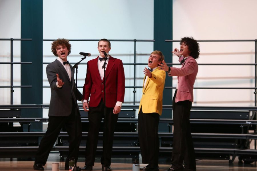Enthusiastically, seniors Finn Cambell, Brody Shulda, Carter Harvey and Brayden Heath sing together in a quartet. 