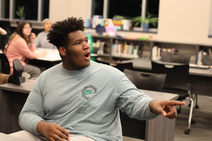 Pointing at the screen, junior Adam McClendon reacts to the question his group was given. 
