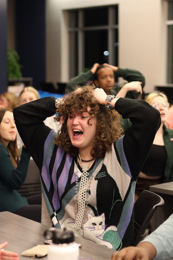 With her hands on her head, junior Keira Patty yells at her teammates to think of the answer to the question. 
