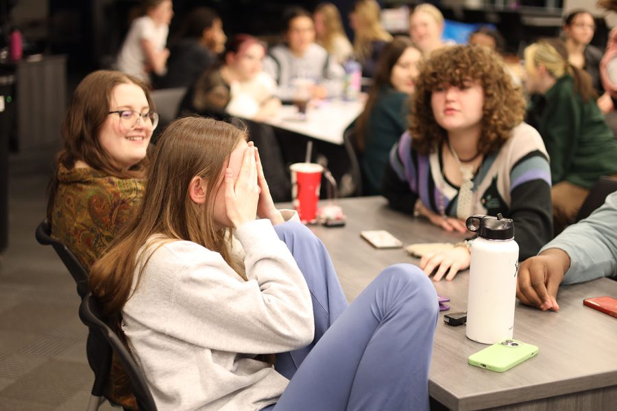 With her head in her hands, junior Michelle Marney tries to think of the answer to a question. 
