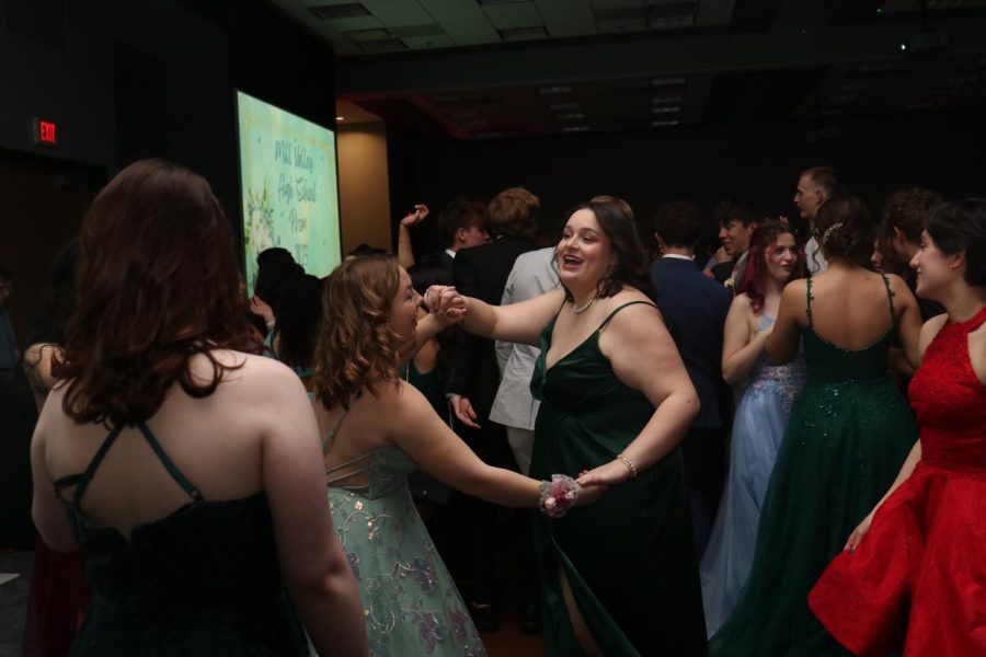 With smiles on their faces, juniors Ella Edwards and Mackenzie Simpson dance.