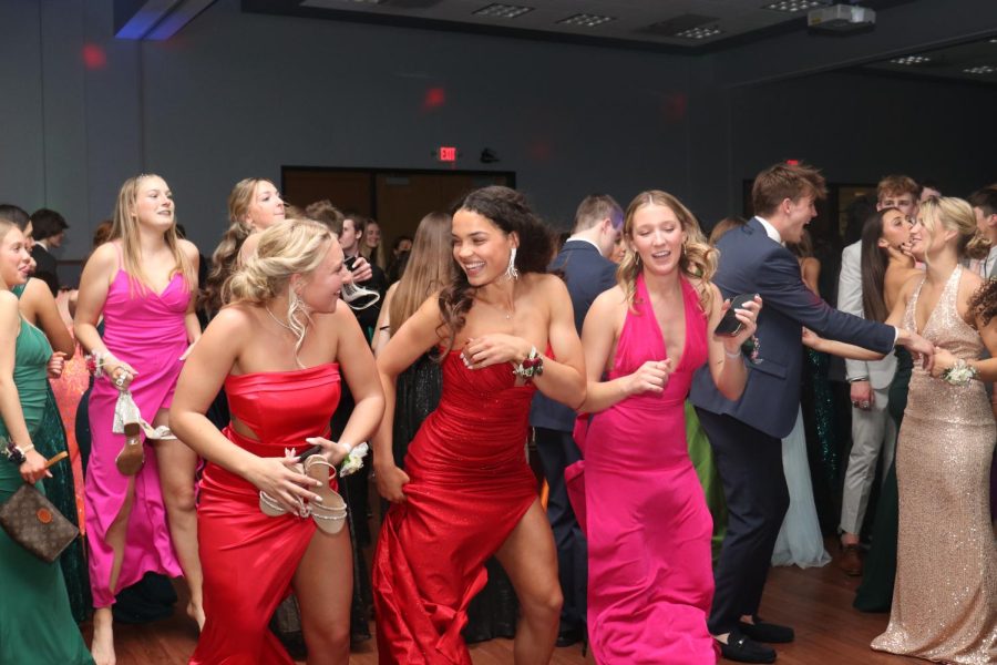 Smiling, seniors Olivia Page and Madeline Schnepf dance to “Wobble”.