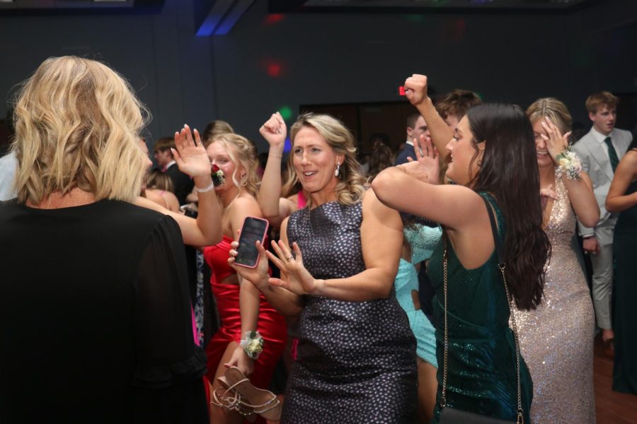 Joining in on the prom fun, gym teacher Sarah Haub dances with the students.