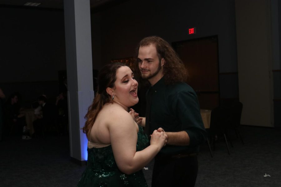 Singing, junior Guss Miller dances with a fellow student.