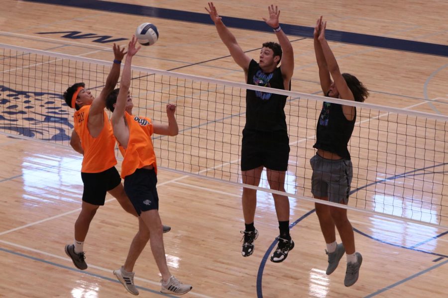 Tipping the ball, junior Kenten Laughman makes it past the block to score a point for his team. 