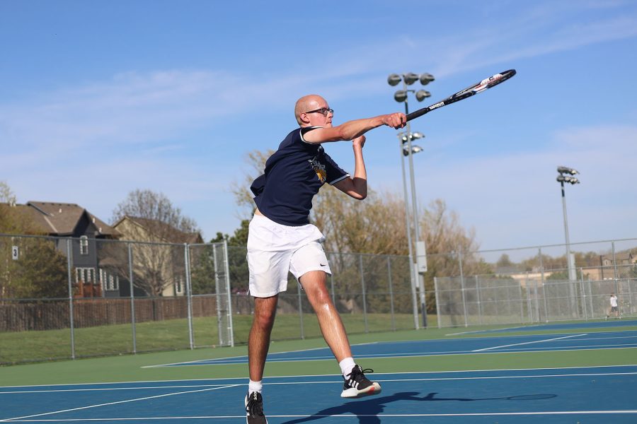 Hitting the ball down over the net, senior Zach Pickett attempts to score points over his opponent.